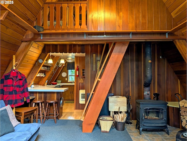 75887 E Rd 28, Rhododendron, OR 97049 - living area featuring a bar, lofted ceiling, a wood stove, and wood walls