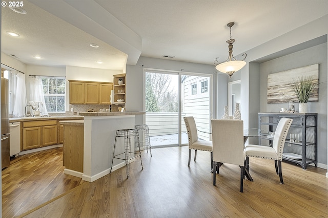 dining room with light wood-type flooring and sink