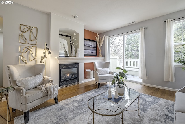 sitting room featuring plenty of natural light and hardwood / wood-style floors