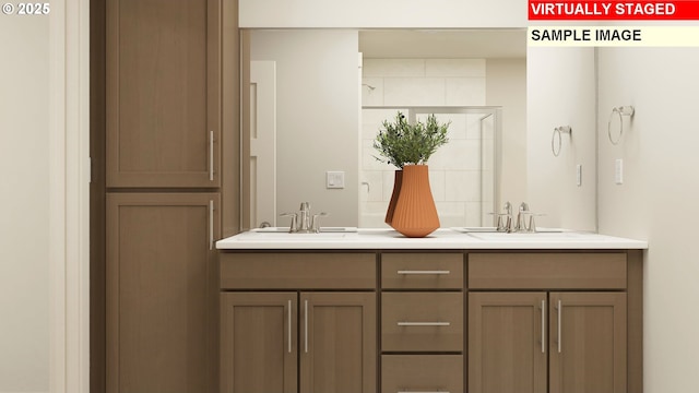 full bathroom featuring double vanity, a tile shower, and a sink