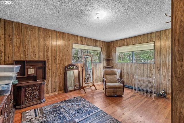 725 Rogue River Hwy, Gold Hill, OR 97525 - living area featuring wood walls, a textured ceiling, and wood finished floors