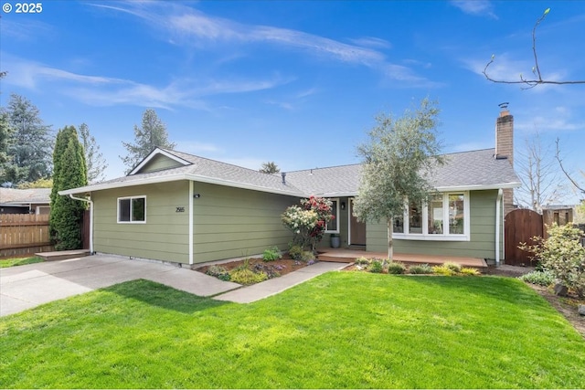 ranch-style house featuring a chimney and roof with shingles