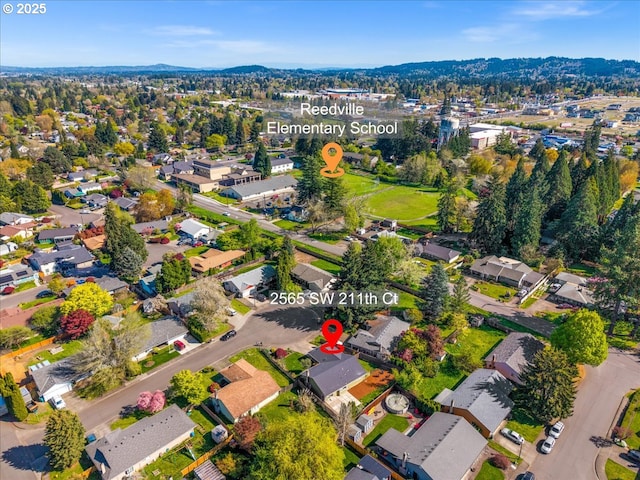 aerial view of property and surrounding area featuring nearby suburban area