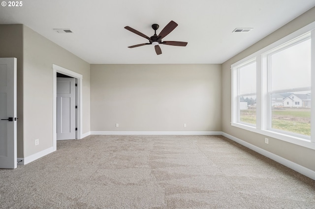 carpeted empty room featuring ceiling fan