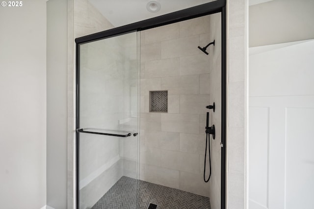 bathroom featuring a shower with shower door