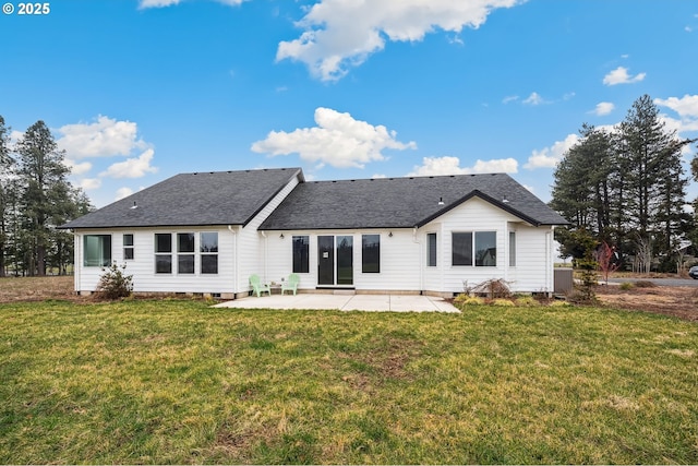 rear view of property with a yard and a patio