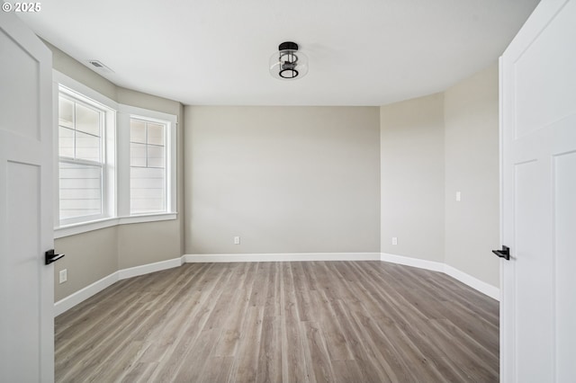 spare room with light wood-type flooring