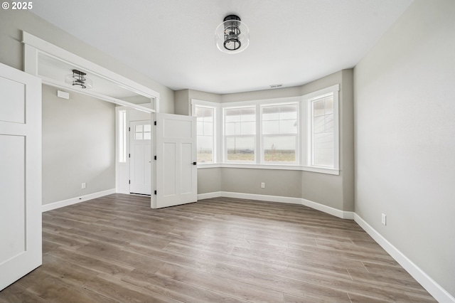 empty room with hardwood / wood-style flooring