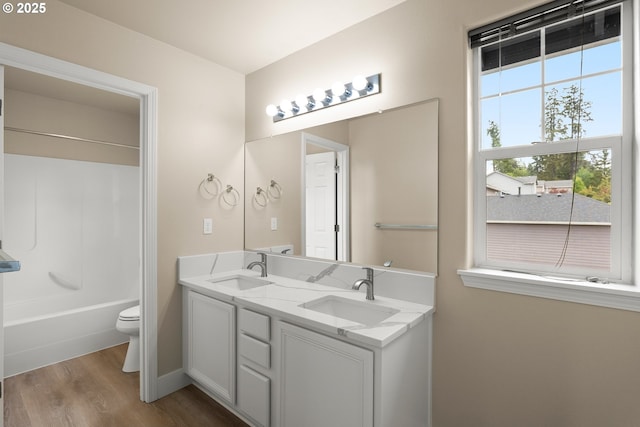 111 SE 49th Ct, Hillsboro, OR 97123 - full bathroom with wood finished floors, toilet, double vanity, shower / tub combination, and baseboards