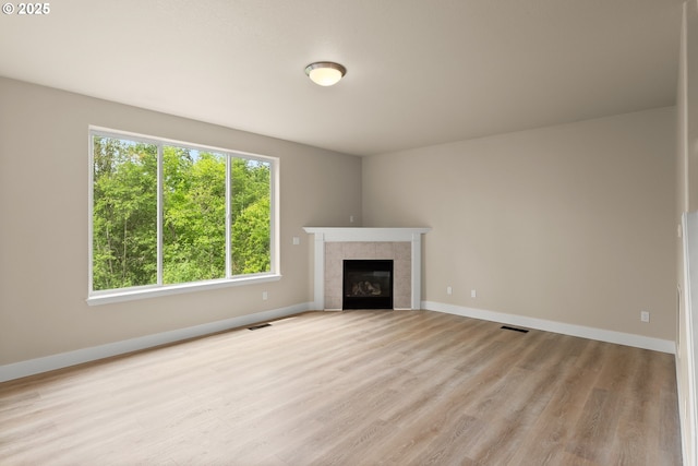 111 SE 49th Ct, Hillsboro, OR 97123 - unfurnished living room with wood finished floors, a fireplace, and baseboards