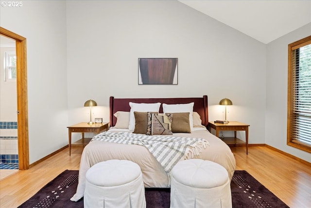 bedroom with lofted ceiling and hardwood / wood-style floors