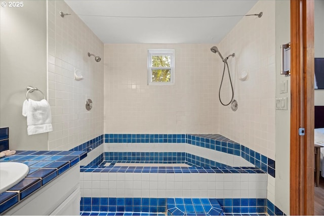 bathroom with vanity and tiled shower