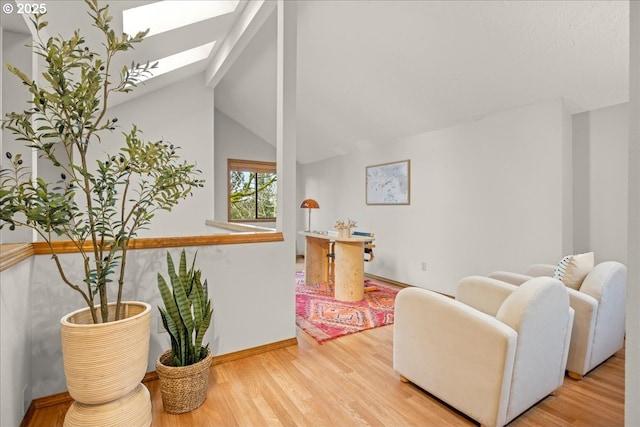 interior space with lofted ceiling with skylight and light wood-type flooring