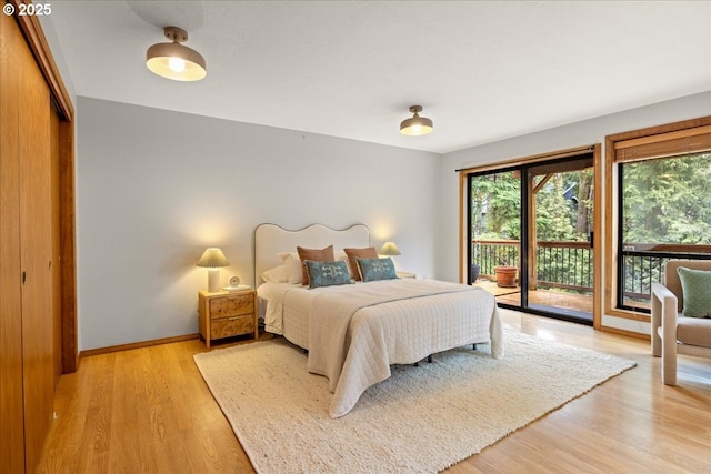 bedroom with access to exterior and light wood-type flooring