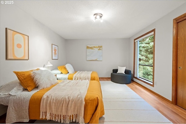 bedroom featuring wood-type flooring and a textured ceiling