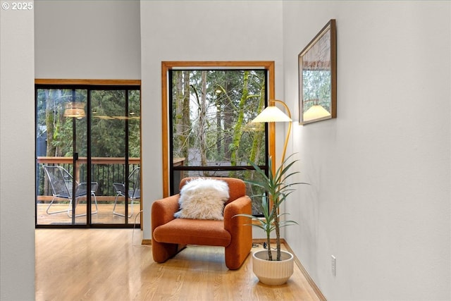 sitting room with wood-type flooring