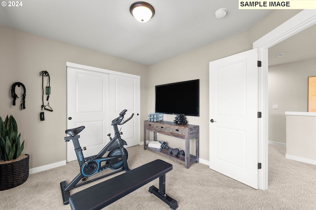 workout room featuring light colored carpet