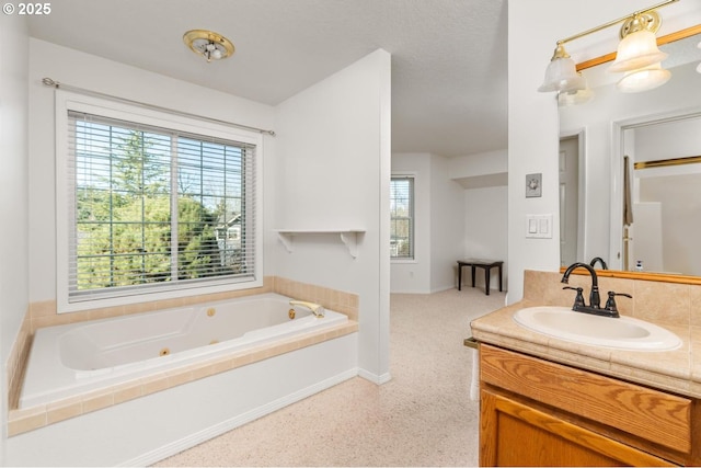 bathroom with vanity and a washtub