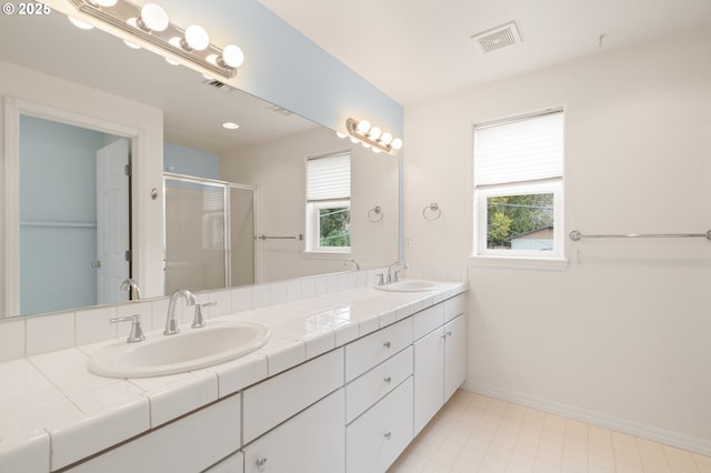7408 SW Capitol Hwy, Portland, OR 97219 - full bathroom featuring double vanity, a stall shower, healthy amount of natural light, and tile patterned flooring