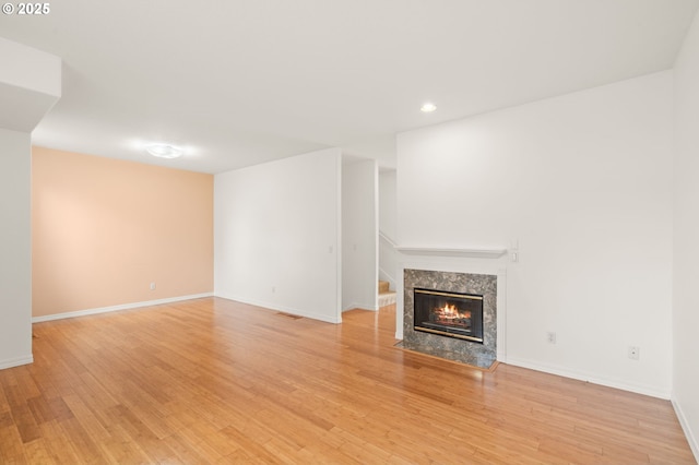 7408 SW Capitol Hwy, Portland, OR 97219 - unfurnished living room featuring recessed lighting, light wood finished floors, and a premium fireplace