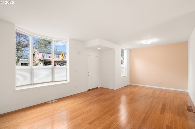 7408 SW Capitol Hwy, Portland, OR 97219 - empty room with light wood-style flooring and healthy amount of natural light