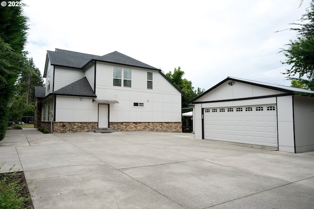 4604 NE 119th St, Vancouver, WA 98686 - view of side of property with an outdoor structure, a shingled roof, and concrete driveway