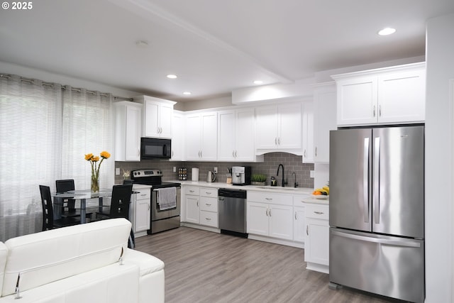 4604 NE 119th St, Vancouver, WA 98686 - kitchen featuring tasteful backsplash, white cabinets, light countertops, a sink, and stainless steel appliances