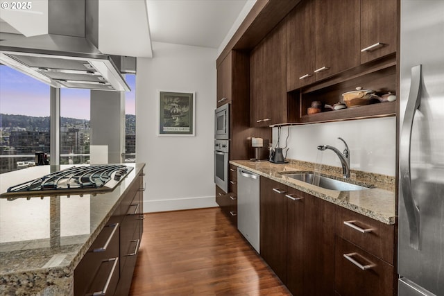 kitchen with a sink, dark brown cabinetry, stainless steel appliances, and dark wood-style floors