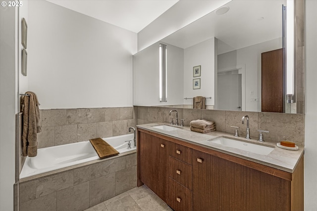 full bath featuring double vanity, a sink, and a garden tub