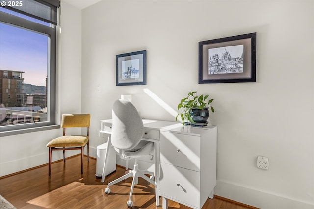home office featuring baseboards and wood finished floors
