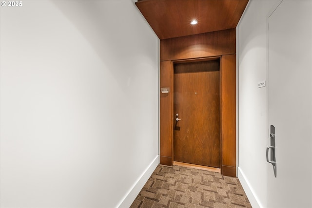 corridor featuring baseboards, carpet flooring, and recessed lighting
