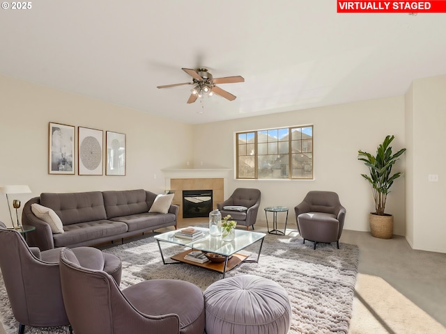 living room with a fireplace, ceiling fan, and carpet flooring