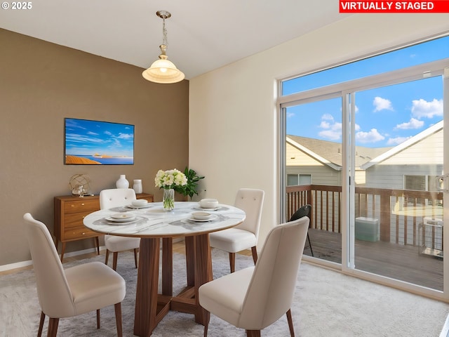 dining space with light colored carpet