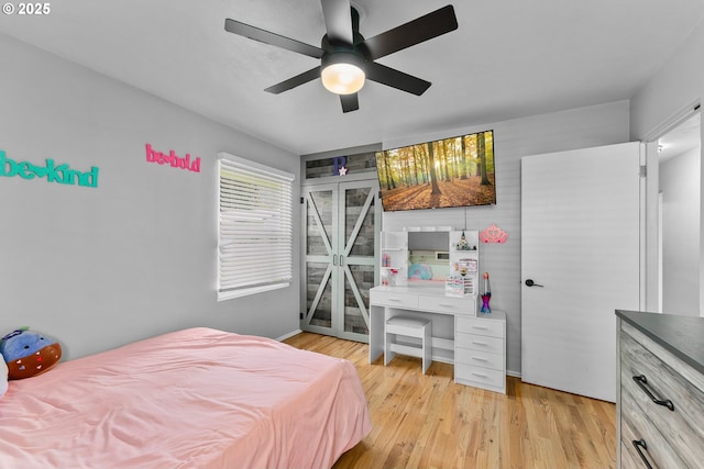 bedroom with access to outside, a ceiling fan, and light wood-style floors