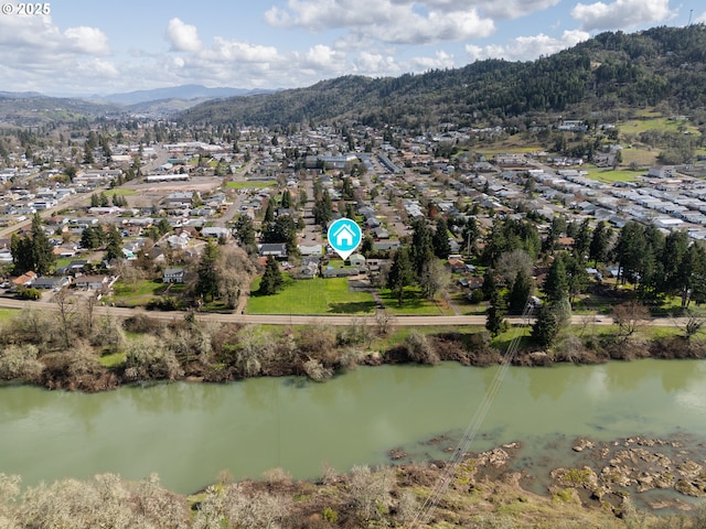 birds eye view of property with a water and mountain view