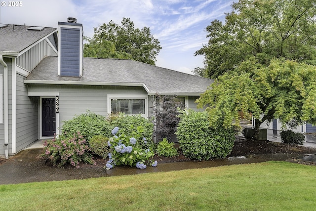 8396 SW Mohawk St, Tualatin, OR 97062 - view of property exterior featuring a chimney, a lawn, and a shingled roof