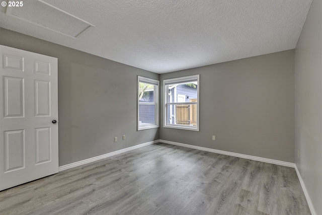 8396 SW Mohawk St, Tualatin, OR 97062 - unfurnished room featuring wood finished floors, a textured ceiling, and attic access