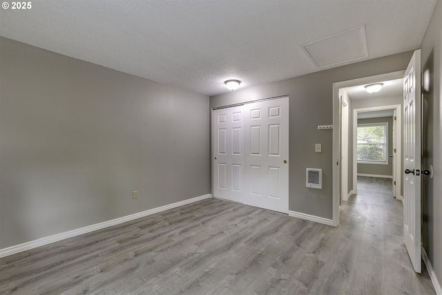 8396 SW Mohawk St, Tualatin, OR 97062 - unfurnished bedroom with attic access, wood finished floors, a closet, and a textured ceiling