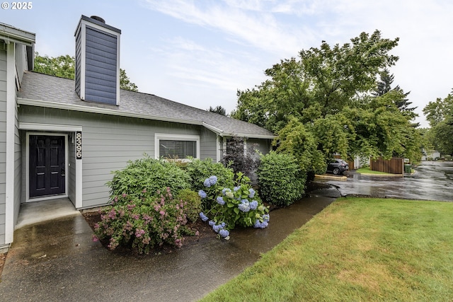 8396 SW Mohawk St, Tualatin, OR 97062 - view of side of property featuring a chimney, a yard, and a shingled roof