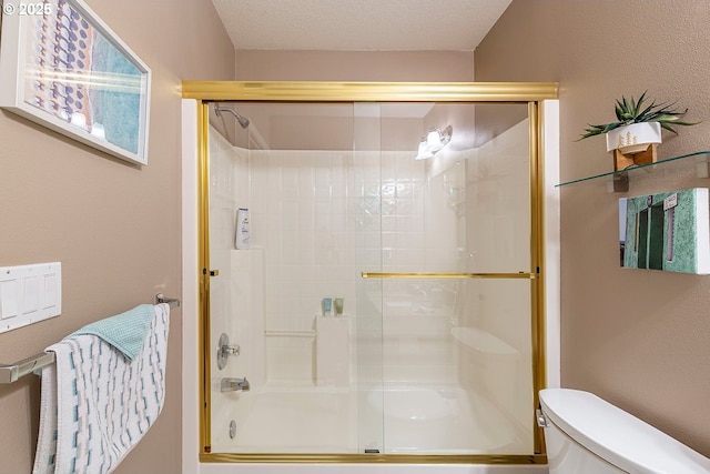 full bath featuring toilet, combined bath / shower with glass door, and a textured ceiling