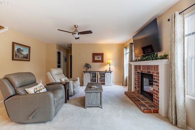 living room with light carpet, ceiling fan, and a brick fireplace