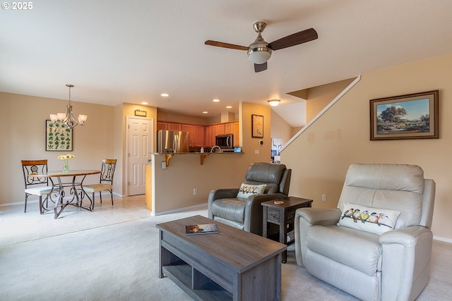 living room featuring baseboards, ceiling fan, recessed lighting, and light colored carpet