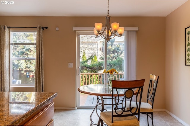 dining area featuring a chandelier, baseboards, and light tile patterned floors