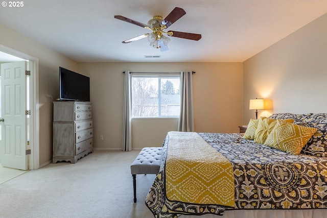 bedroom with baseboards, a ceiling fan, visible vents, and light colored carpet