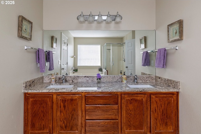 full bath with double vanity, a garden tub, a shower stall, and a sink