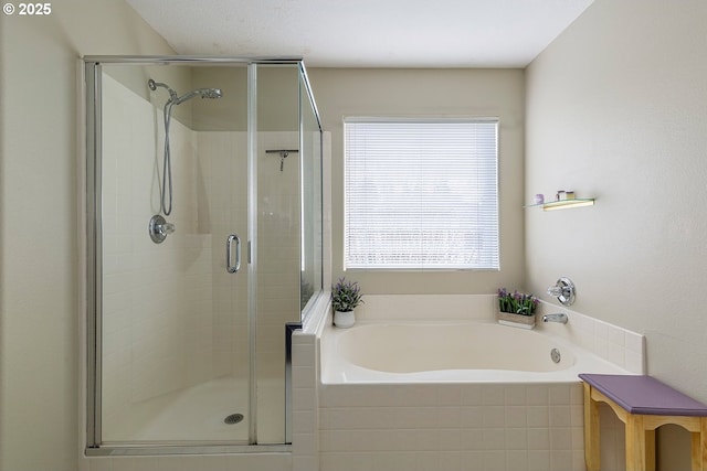 bathroom featuring a shower stall and a bath