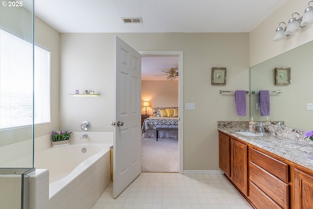 ensuite bathroom featuring connected bathroom, vanity, visible vents, a bath, and tile patterned floors