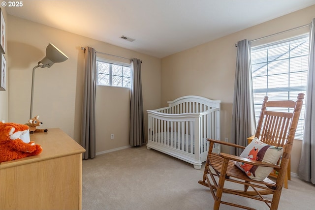 bedroom featuring light carpet, baseboards, and visible vents