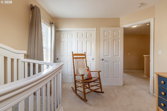 bedroom featuring a closet and light colored carpet