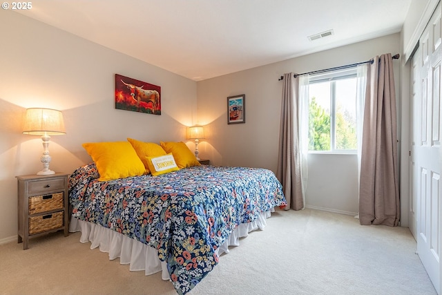 carpeted bedroom with baseboards, visible vents, and a closet